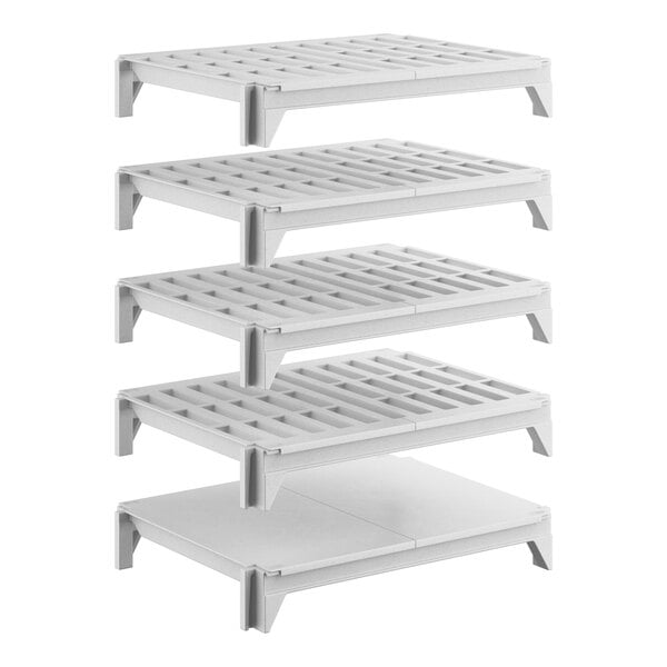 A set of five white shelving units, including four vented shelves and one solid shelf, designed for stationary storage.