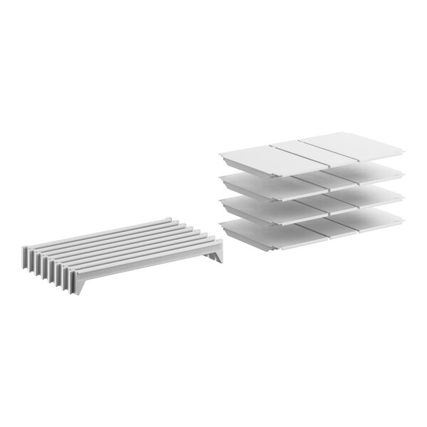 A stack of white plastic shelves with slats.
