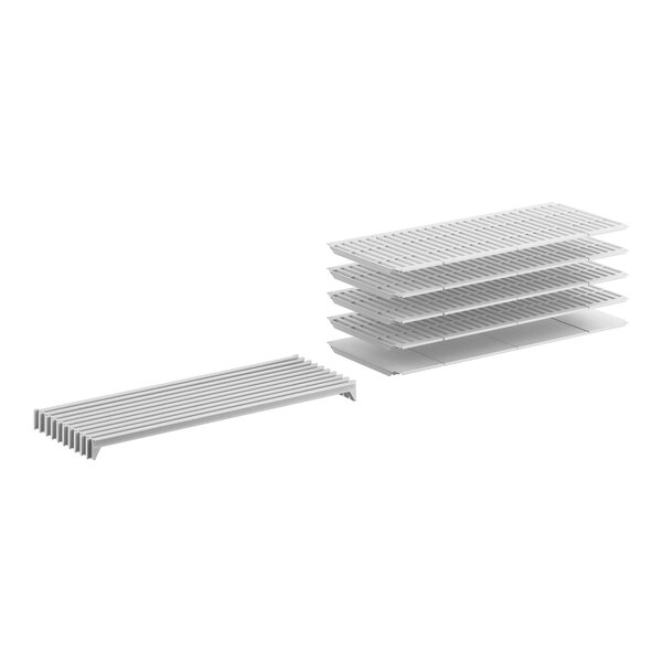 A stack of white plastic shelves with 3 vented and 1 solid white shelves.