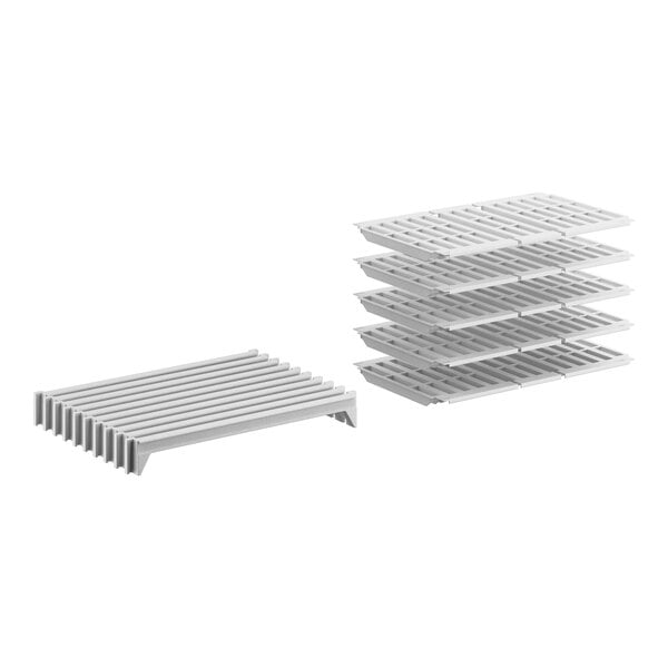 A stack of white plastic Cambro Camshelving® stationary shelves with slats.