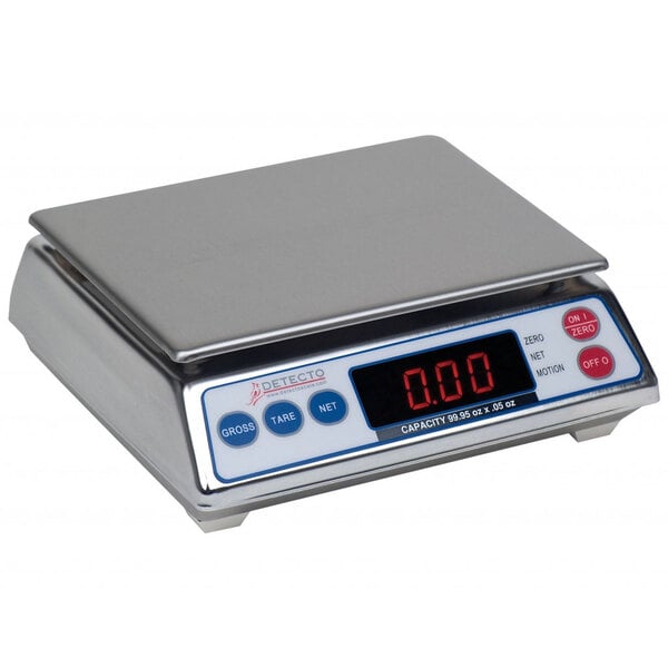 A silver Cardinal Detecto digital portion scale on a counter with red numbers displayed.