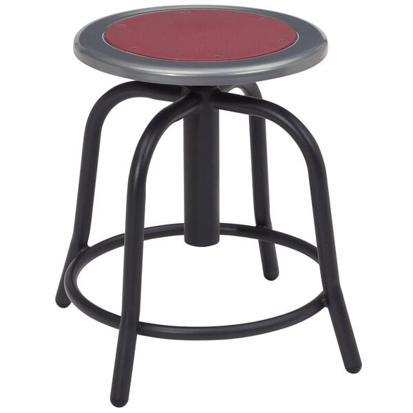 A National Public Seating lab stool with a burgundy steel seat and black metal base.