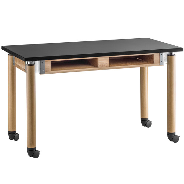 A black and wood table with wheels.