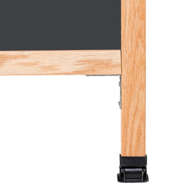 A wooden A-frame with a black chalkboard on it.