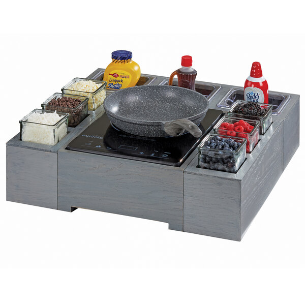 A Cal-Mil Ashwood Gray Oak glass jar unit on a kitchen counter.