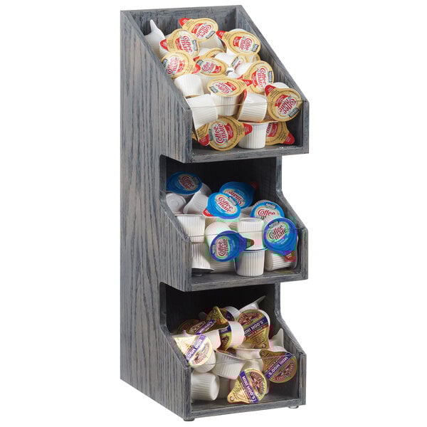 A Cal-Mil Ashwood Gray Oak 3-tier condiment display.