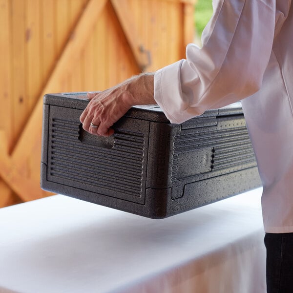 a person holding a black box