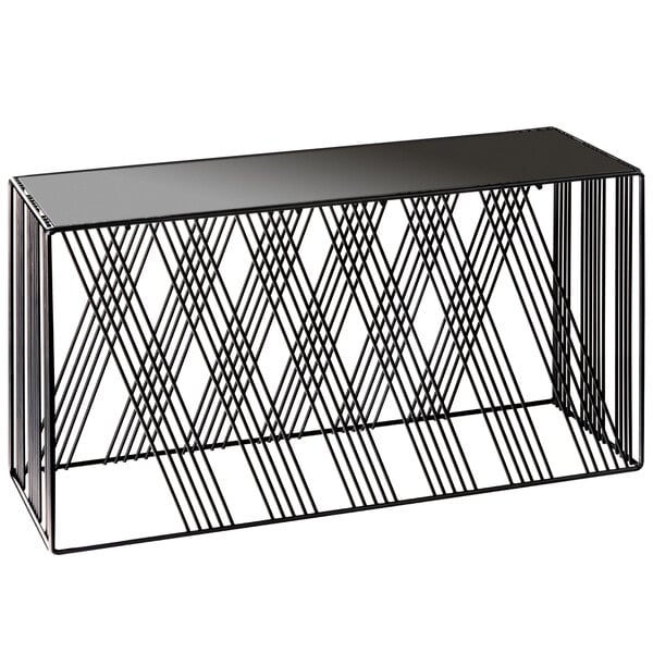 A black metal rectangular riser with geometric design on a black table.