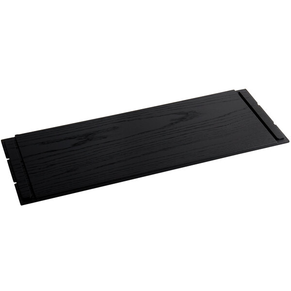 A black wooden rectangular riser shelf with notched edges.