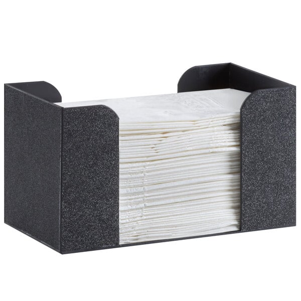 A black Cal-Mil napkin holder with a stack of napkins inside.