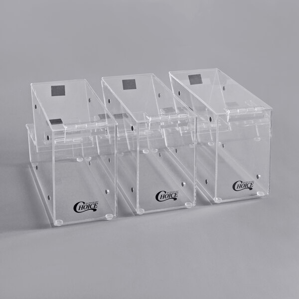 Three clear plastic Choice stackable candy and topping dispensers with notches.