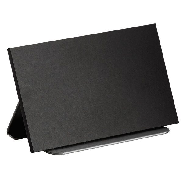 A black rectangular Cal-Mil chalkboard sign on a stand.