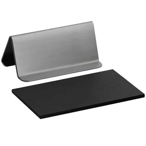 A black rectangular metal stand with a silver rectangular chalkboard sign on it.