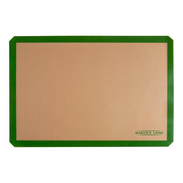 A tan rectangular Baker's Lane silicone baking mat with a green border.