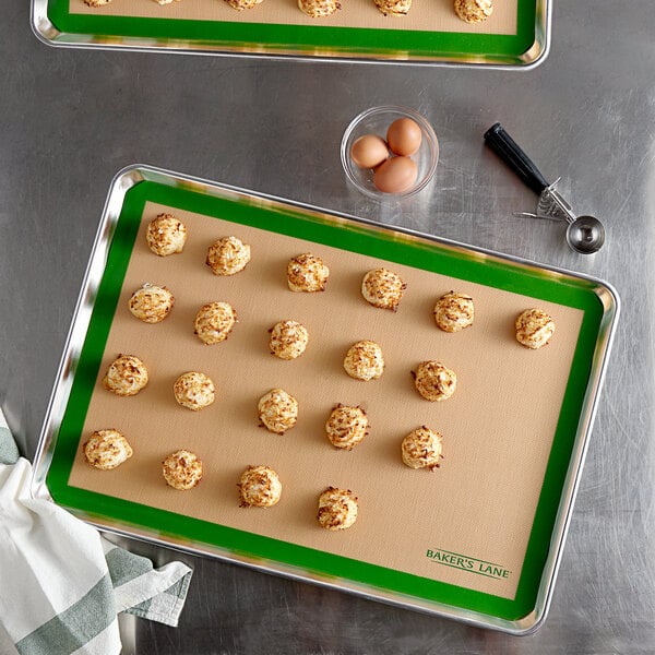 Two Baker's Lane baking mats on baking trays with cookies on them.