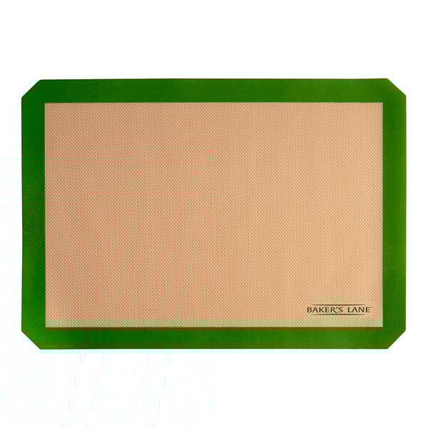 A green and tan baking mat with a brown border.