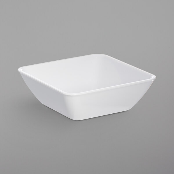 A white Dinex square SAN plastic bowl.