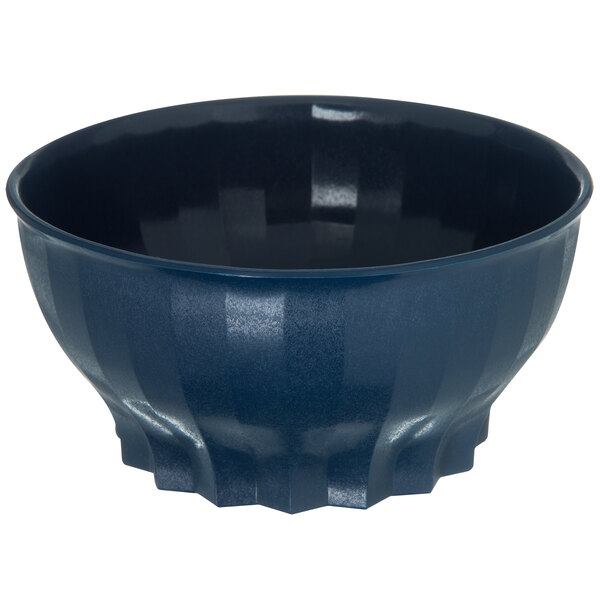 A dark blue Dinex convection bowl with wavy edges and a black rim.