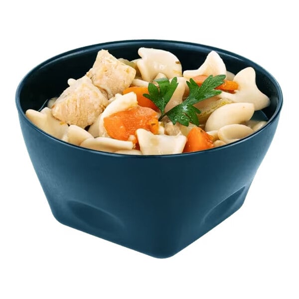 A dark blue high-temp convection bowl filled with chicken noodle soup, featuring noodles, chicken pieces, carrots, and a parsley garnish.