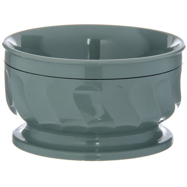 A close up of a Dinex Turnbury sage insulated bowl with a pedestal base.