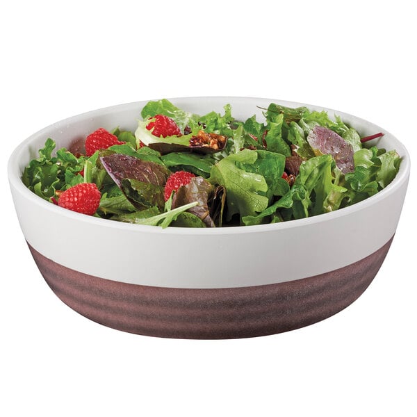 a bowl of salad with raspberries