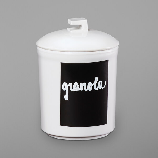 A white Cal-Mil notched lid on a white jar with a black label.