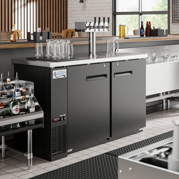 An Avantco black kegerator on a bar counter.