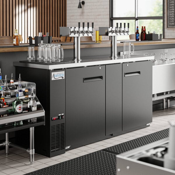 An Avantco black kegerator with four beer taps on a counter.