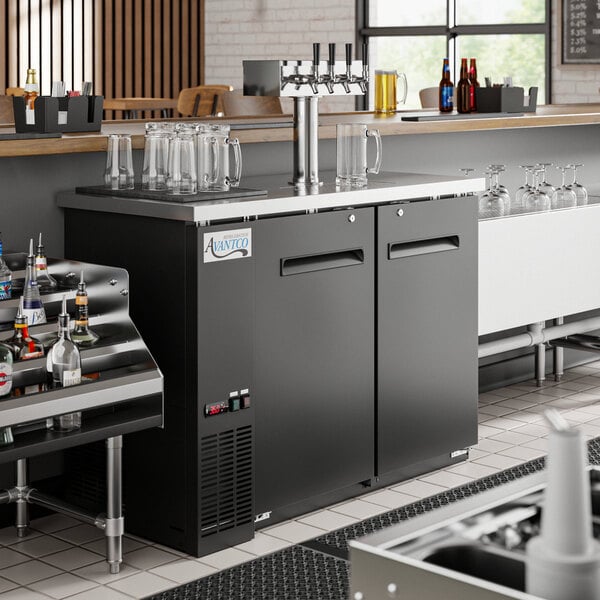 An Avantco beer dispenser on a bar counter with several taps.