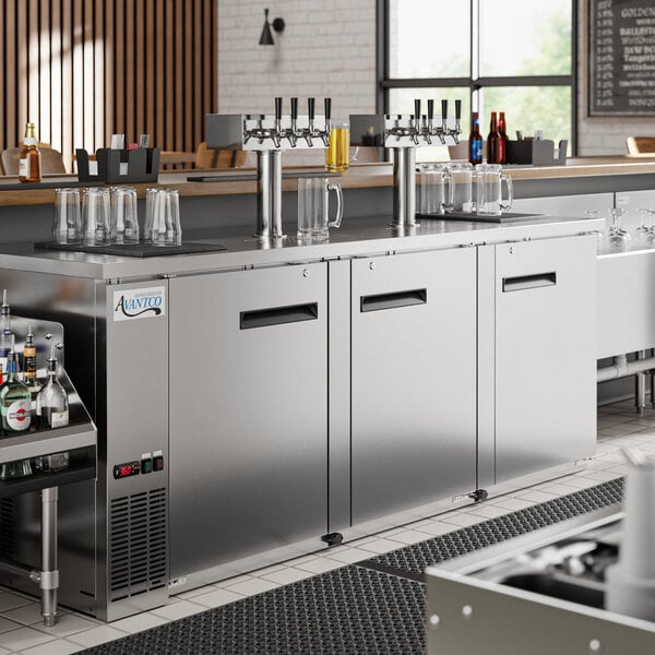 An Avantco stainless steel counter with four beer taps.