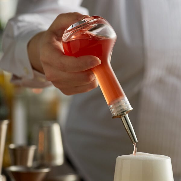 Bitters being poured into a drink