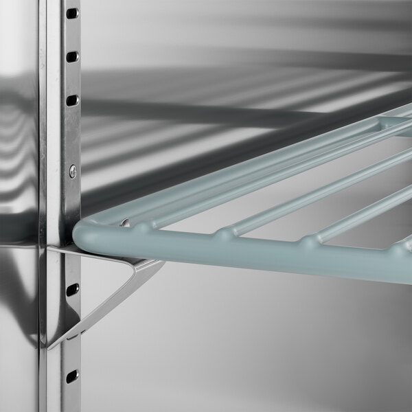 An Avantco stainless steel shelf for two kegs with a metal bar on it.
