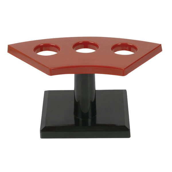 a red and black object with four holes