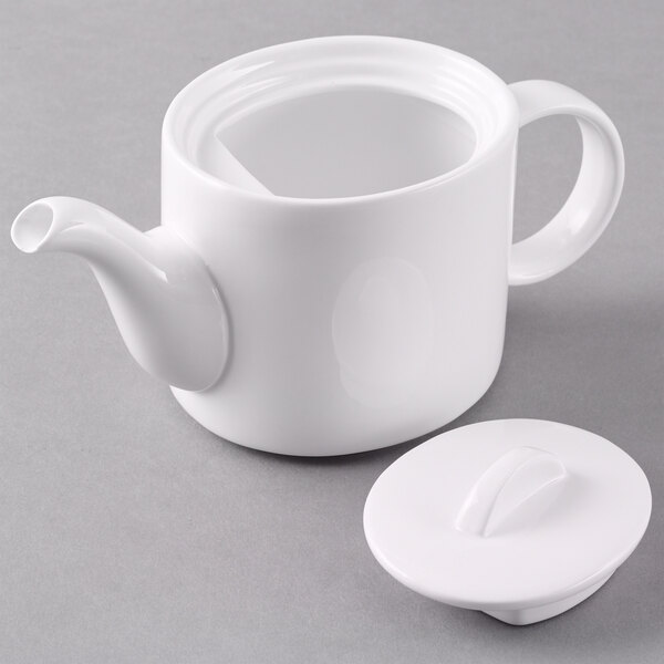 An Arcoroc white teapot with a lid.
