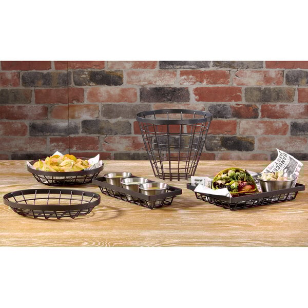A group of GET Vector metal wire baskets with food on a table.