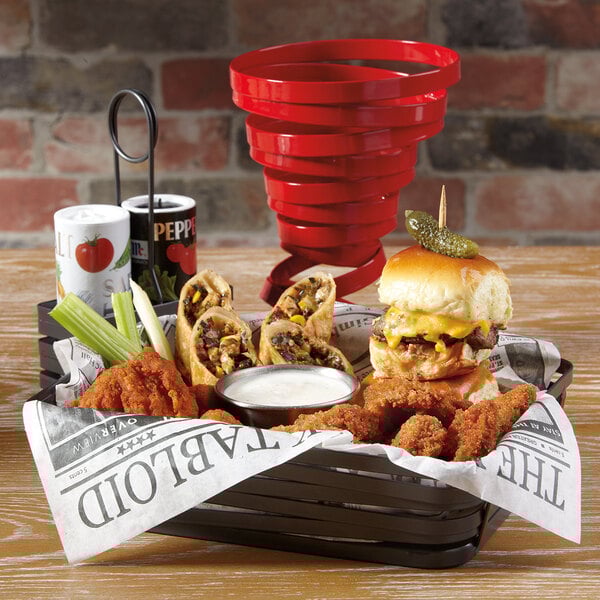 A GET red wire basket filled with food on a table.