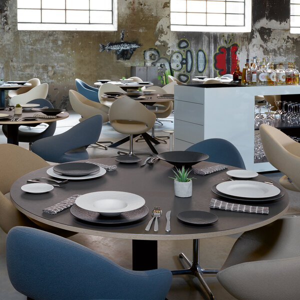 A table set with Villeroy & Boch black shale porcelain plates and silverware.