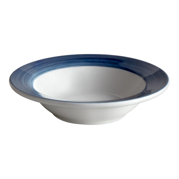 A close-up of a white porcelain bowl with a steel blue band.