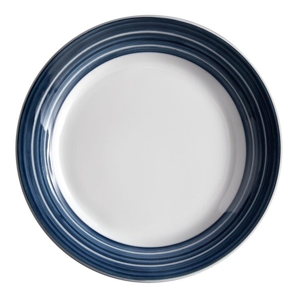 A close-up of a Libbey Lunar Bright white porcelain plate with blue steel stripes and a white rim.