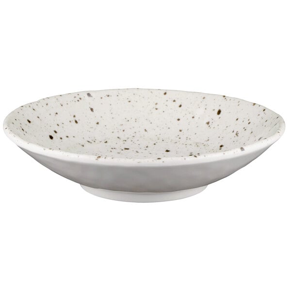 A white melamine bowl with black speckled spots.