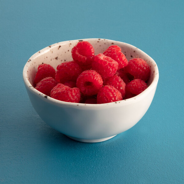 A Macchiato melamine bowl filled with raspberries.