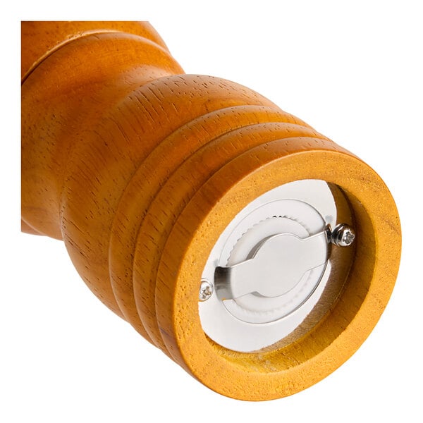 A close up of a matte brown wooden pepper mill.