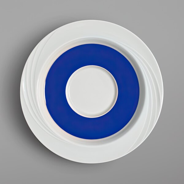 A white saucer with a blue and white rim.