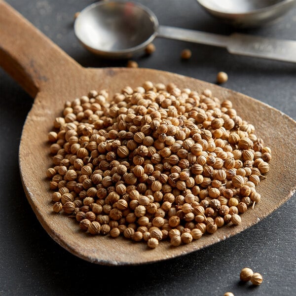 Coriander seeds on a wooden spoon