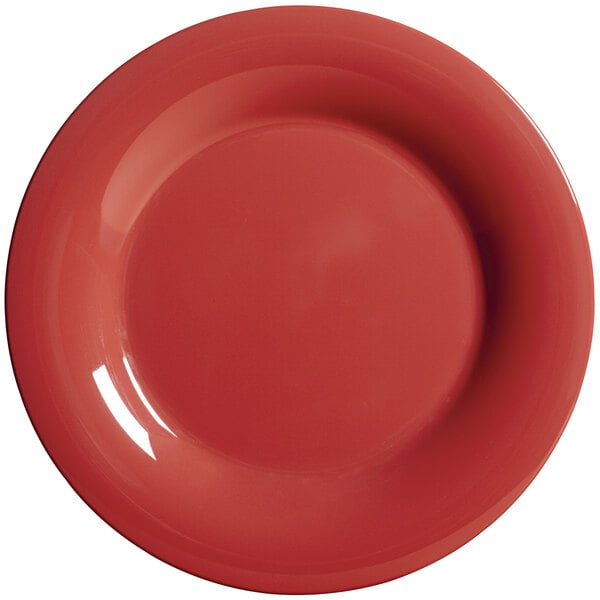 A close-up of a cranberry GET Diamond Harvest melamine plate with a wide rim.