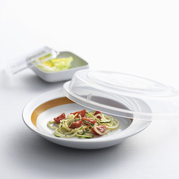 A Schonwald semi-translucent polypropylene plate cover on a plate of food with a lid.