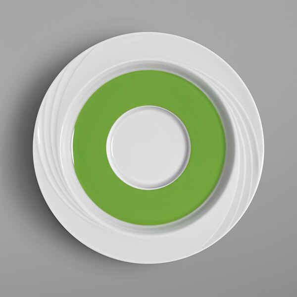 A close-up of a white Schonwald porcelain saucer with a white rim and light green center.