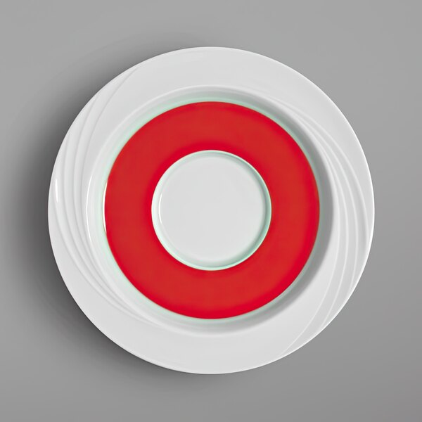 A white saucer with a red and white circle on it.