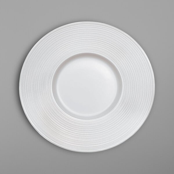 A white Villeroy & Boch bone porcelain plate with a spiral pattern.