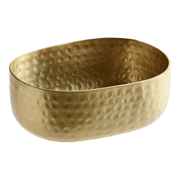 An American Metalcraft gold hammered aluminum oval bowl with a patterned design.